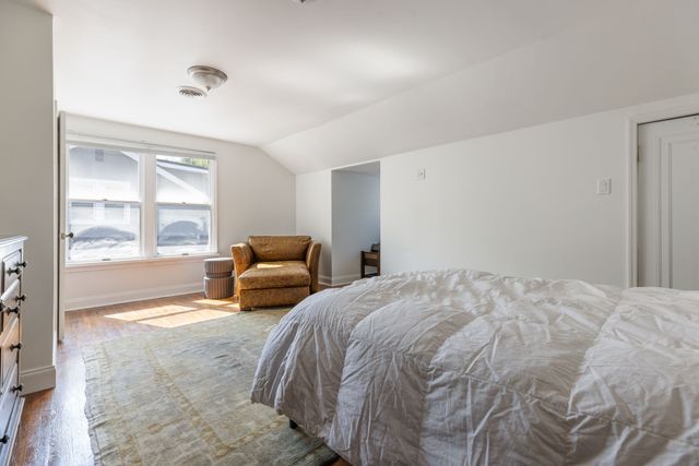 a bedroom with a large bed and a large window