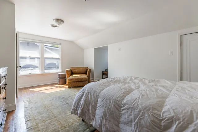 a bedroom with a large bed and a large window