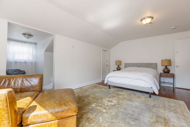 a bedroom with a bed and a couch