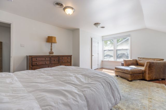 a bedroom with a bed and a couch