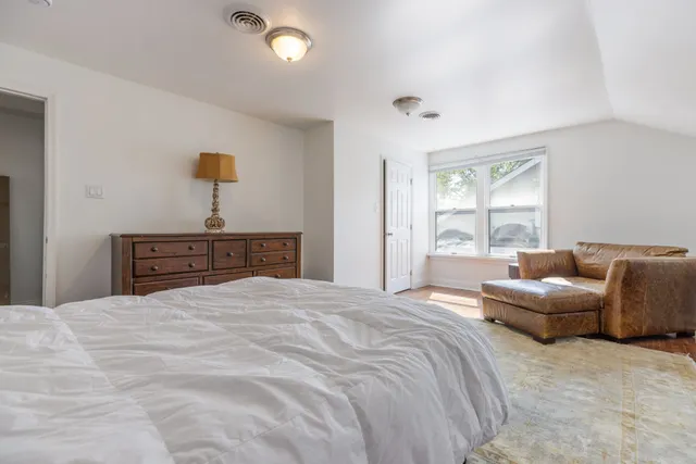 a bedroom with a bed and a couch