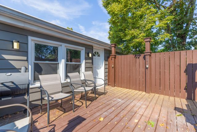 a view of backyard with a deck and wooden floor