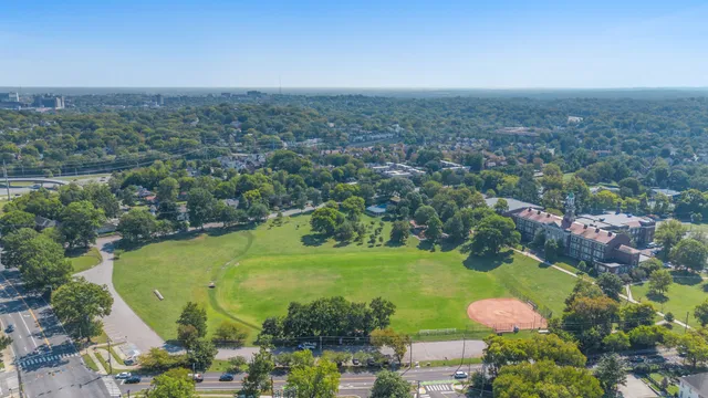 an aerial view of a houses with a yard