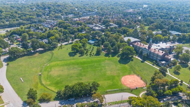 an aerial view of a residential houses with outdoor space and street view