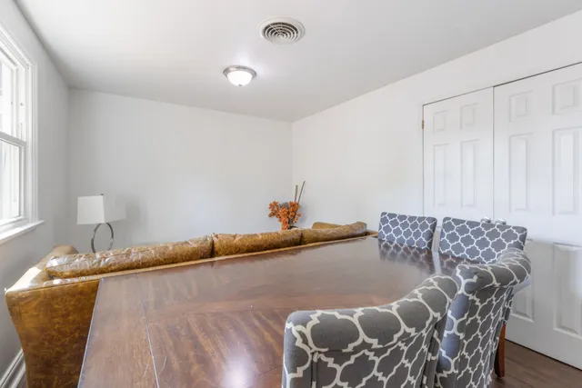 a bed sitting in a bedroom next to a window