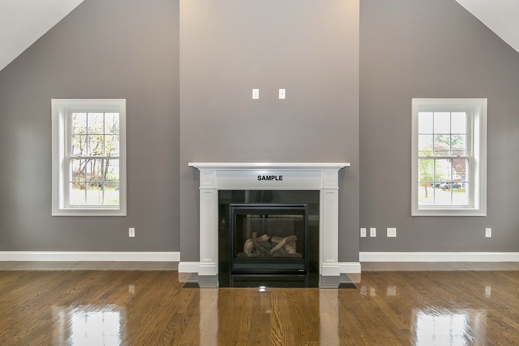 6 Shawsheen Road Billerica, MA 01821 - Photo 5 of 8 a living room with a fireplace and a wooden floor
