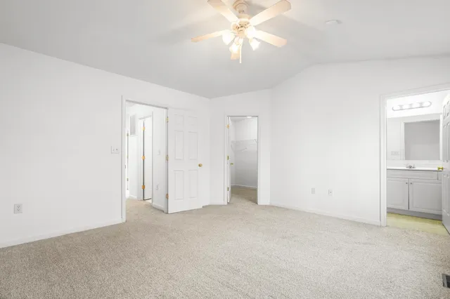 an empty room with chandelier fan