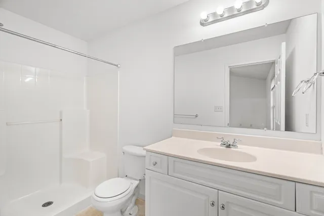 a bathroom with a sink toilet a mirror and shower