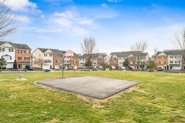 a view of residential houses with yard and lake view