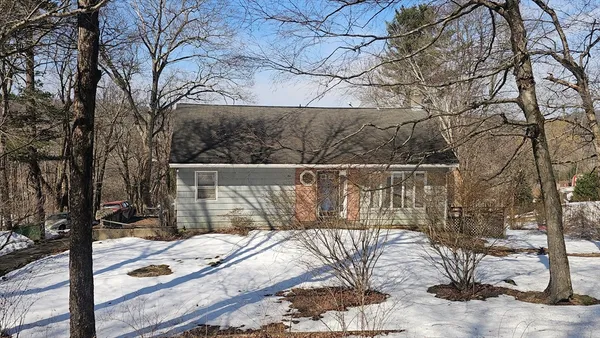 a wooden fence with trees in the background