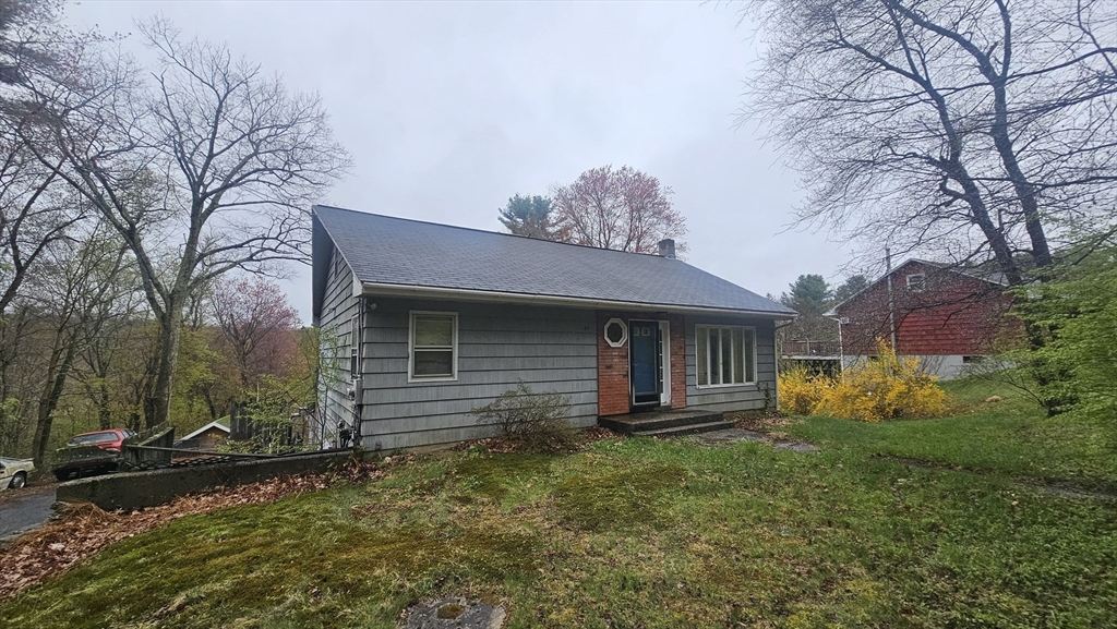 84 Stafford Holland Road Wales, MA 01081 - Photo 2 of 10 a front view of house with yard and trees around