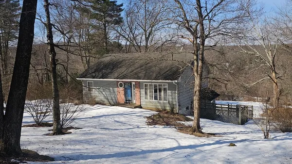 a view of a house with snow on the road