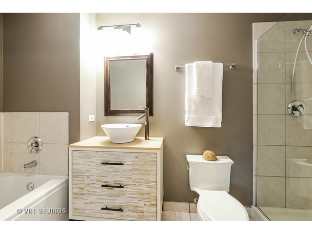 41 East 8th Street, Unit 1105 Chicago, IL 60605 - Photo 12 of 15 a bathroom with a sink a toilet and shower