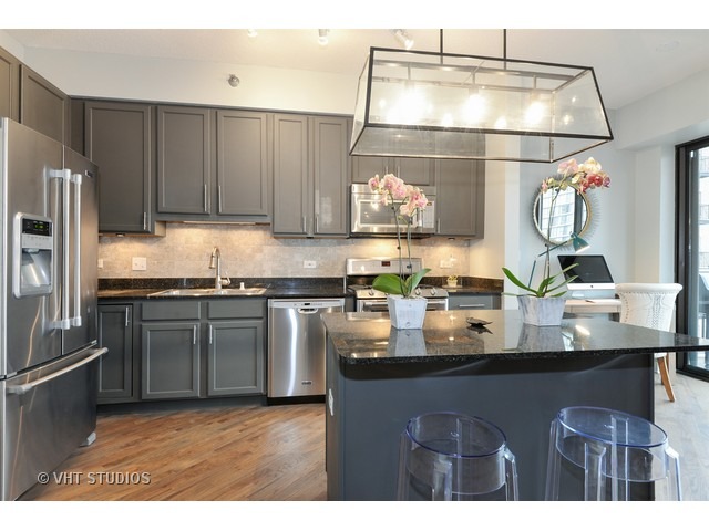 41 East 8th Street, Unit 1105 Chicago, IL 60605 - Photo 4 of 15 a kitchen with stainless steel appliances granite countertop a sink and a stove