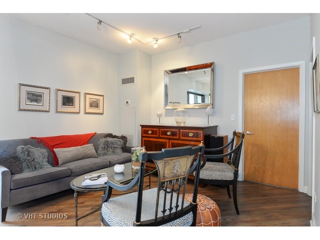 41 East 8th Street, Unit 1105 Chicago, IL 60605 - Photo 9 of 15 a living room with furniture and a wooden floor