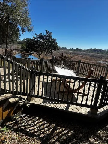 a view of a balcony with wooden floor and outdoor space