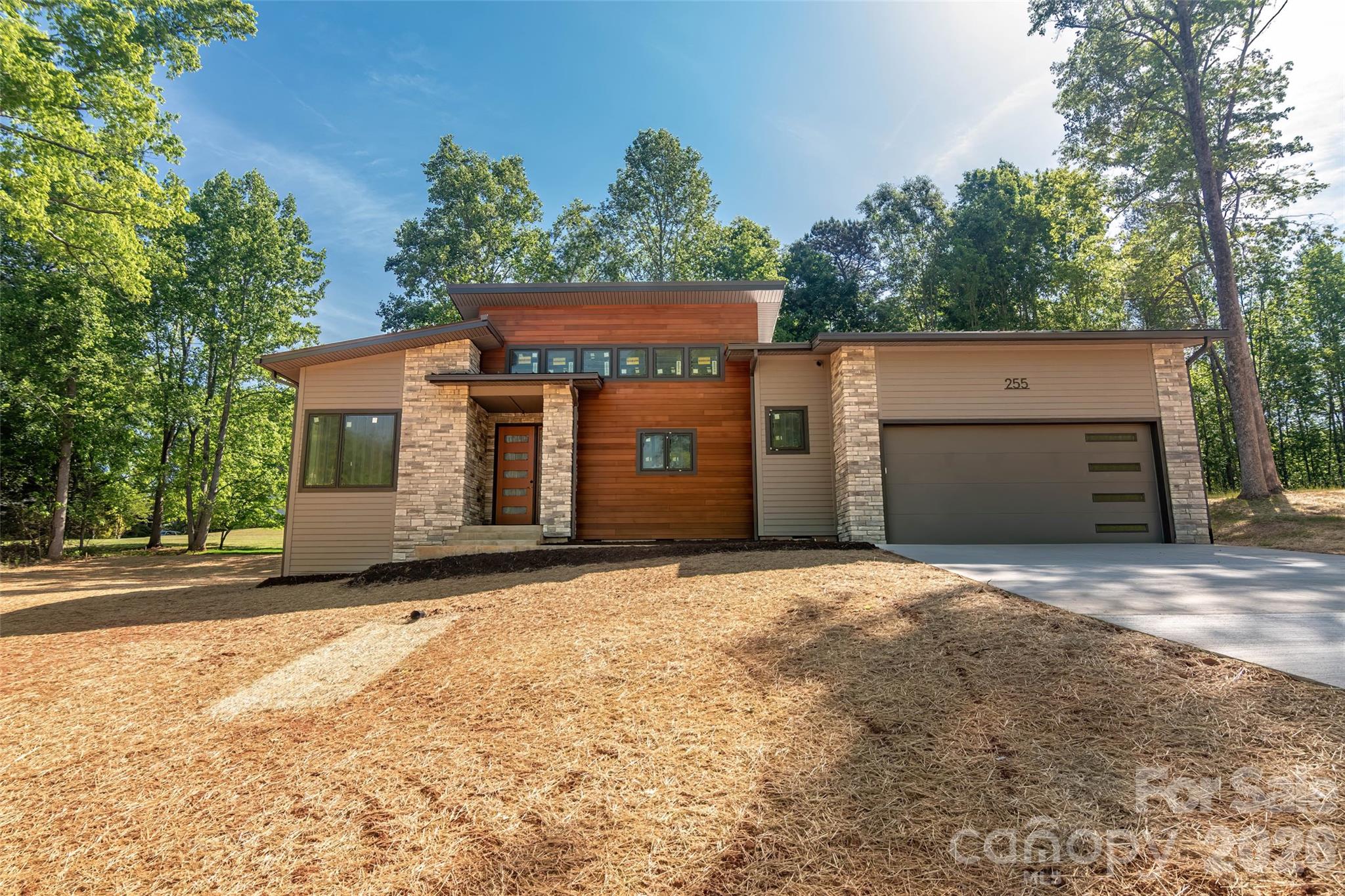 255 Hunters Trace Rutherfordton, NC 28139 - Photo 2 of 19 a front view of a house with a yard and garage