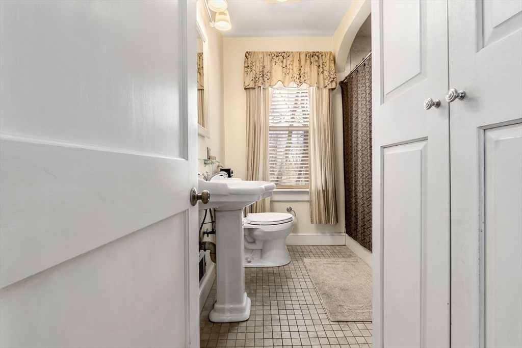 4 Valley Road Danvers, MA 01923 - Photo 16 of 42 a bathroom with a toilet and a shower curtain