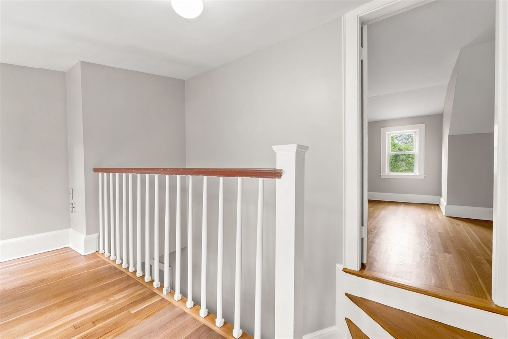 4 Valley Road Danvers, MA 01923 - Photo 21 of 42 a view of a hallway with wooden floor and a living room