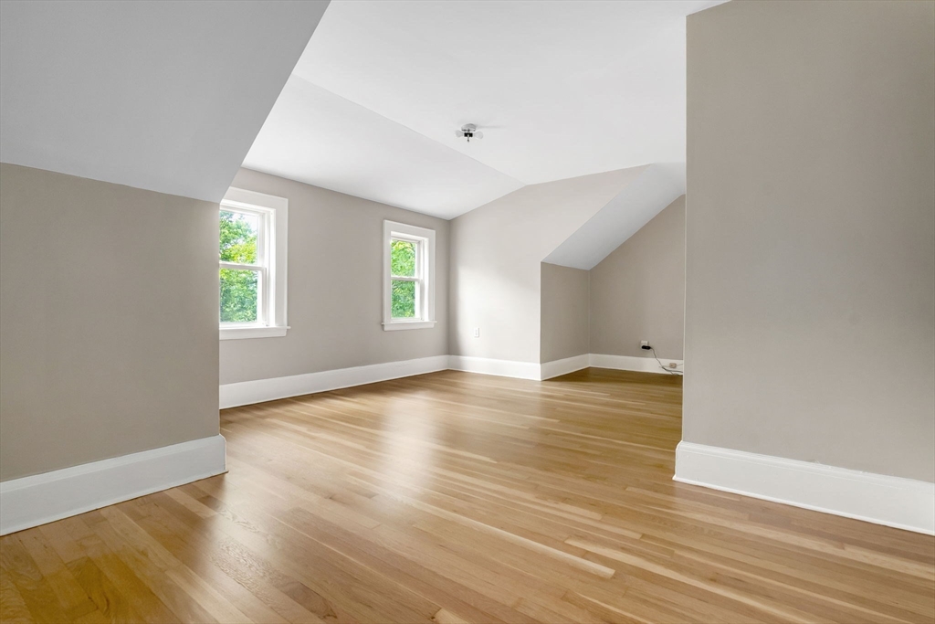 4 Valley Road Danvers, MA 01923 - Photo 23 of 42 an empty room with wooden floor and windows