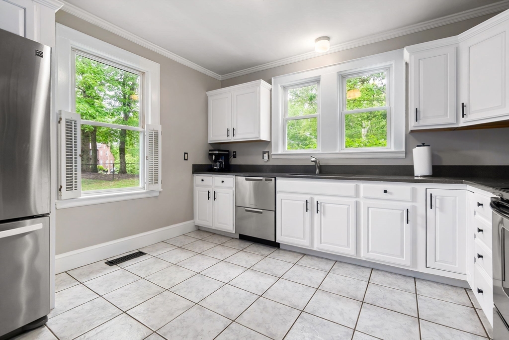 4 Valley Road Danvers, MA 01923 - Photo 10 of 42 a kitchen with white cabinets a window and a sink