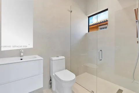 a bathroom with a toilet sink and shower