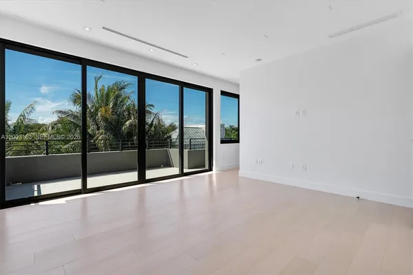 wooden floor in an empty room with large windows