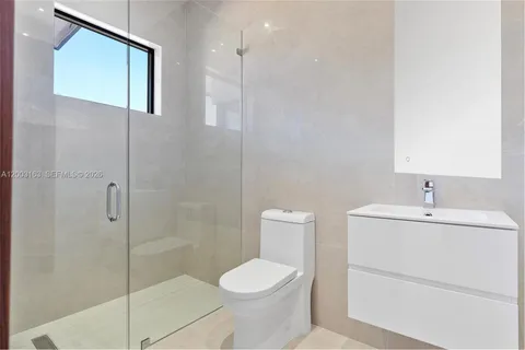 a bathroom with a toilet sink and shower