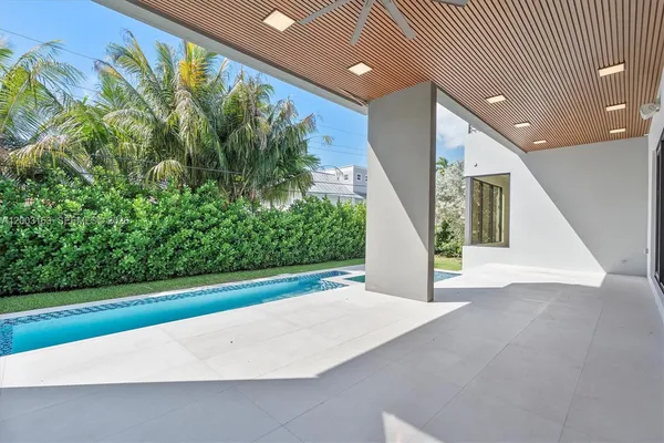 a view of white house with a swimming pool