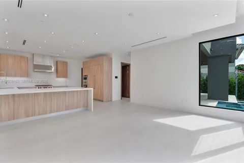 a view of kitchen with granite countertop cabinets and sink