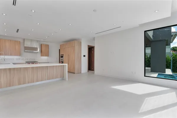 a view of kitchen with granite countertop cabinets and sink