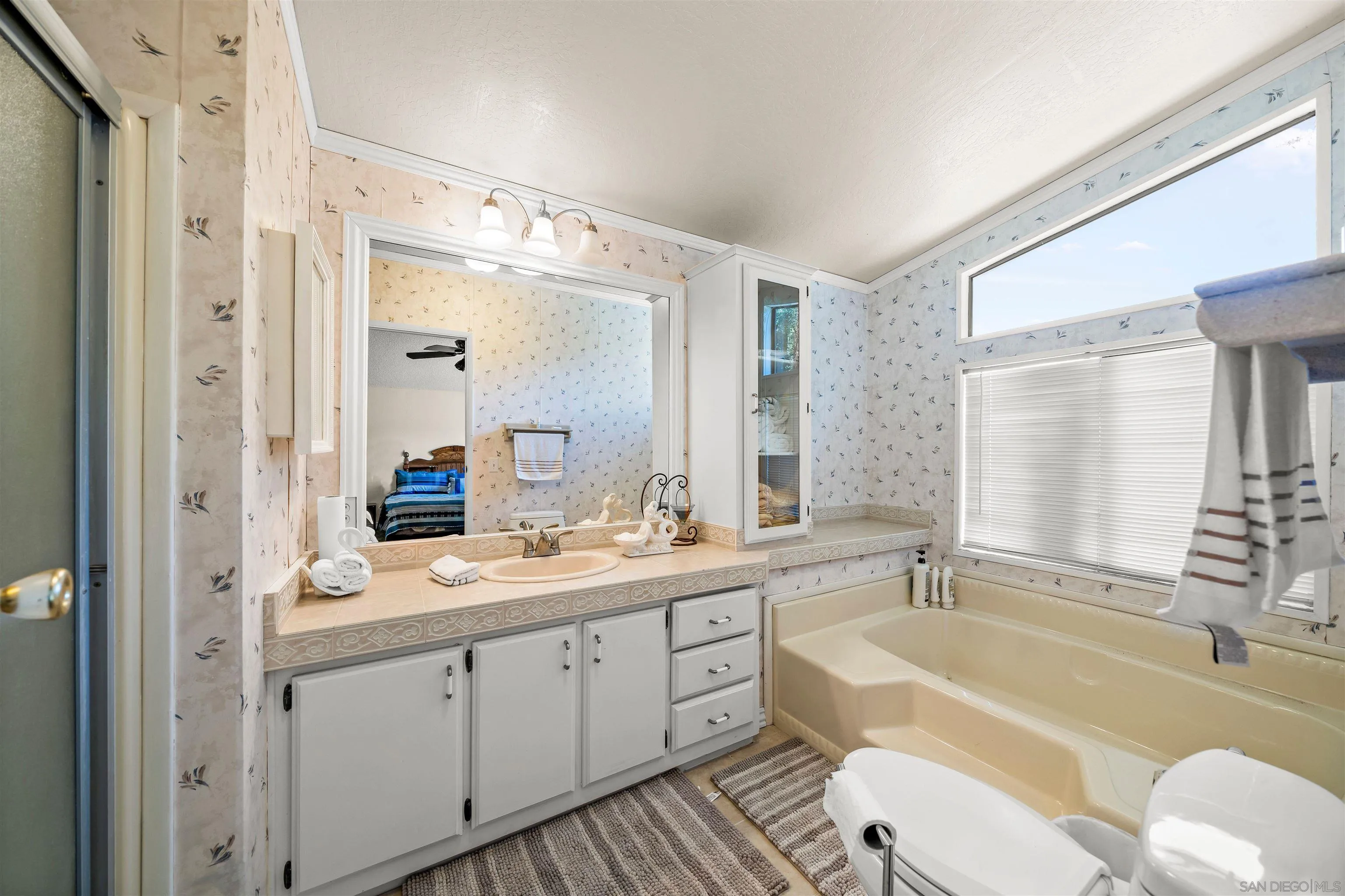 2464 Wynola Road Julian, CA 92036 - Photo 26 of 50 a spacious bathroom with a double vanity sink a large mirror a bathtub and shower
