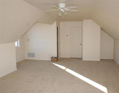 58 Alpine Ranch Road Gypsum, CO 81637 - Photo 14 of 20 an empty room with a ceiling fan and a window