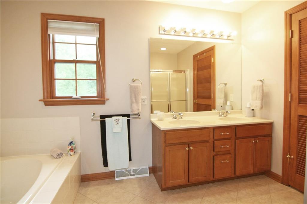 1580 Nine Eighty Road Canonsburg, PA 15317 - Photo 20 of 25 The master bath offers a jet tub, maple double vanity with his and her sinks and shower with glass enclosure. Notice the tile flooring set on the diagonal...