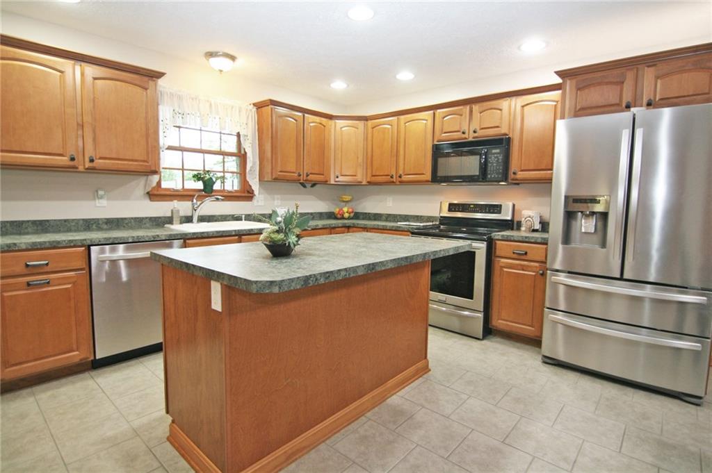 1580 Nine Eighty Road Canonsburg, PA 15317 - Photo 8 of 25 The center island kitchen offers abundant maple cabinetry and counter top space. The center island has a breakfast bar design and offers additional storage.