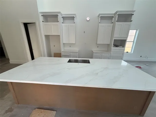 a large white bed in a white room