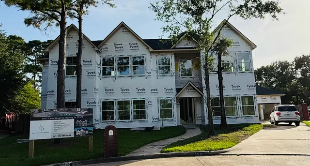 a front view of a house with a yard table and chairs