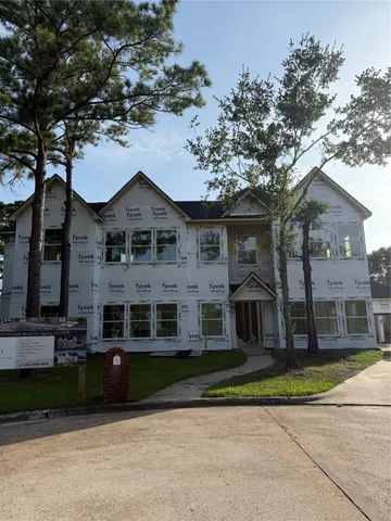 a large tree in front of a house