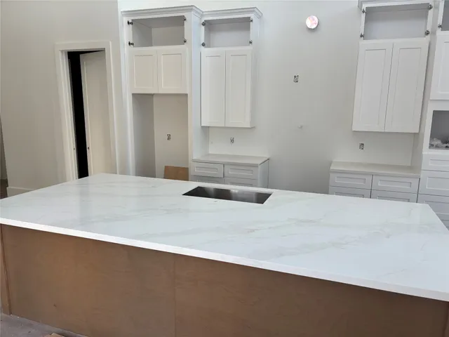 a kitchen with a sink and cabinets
