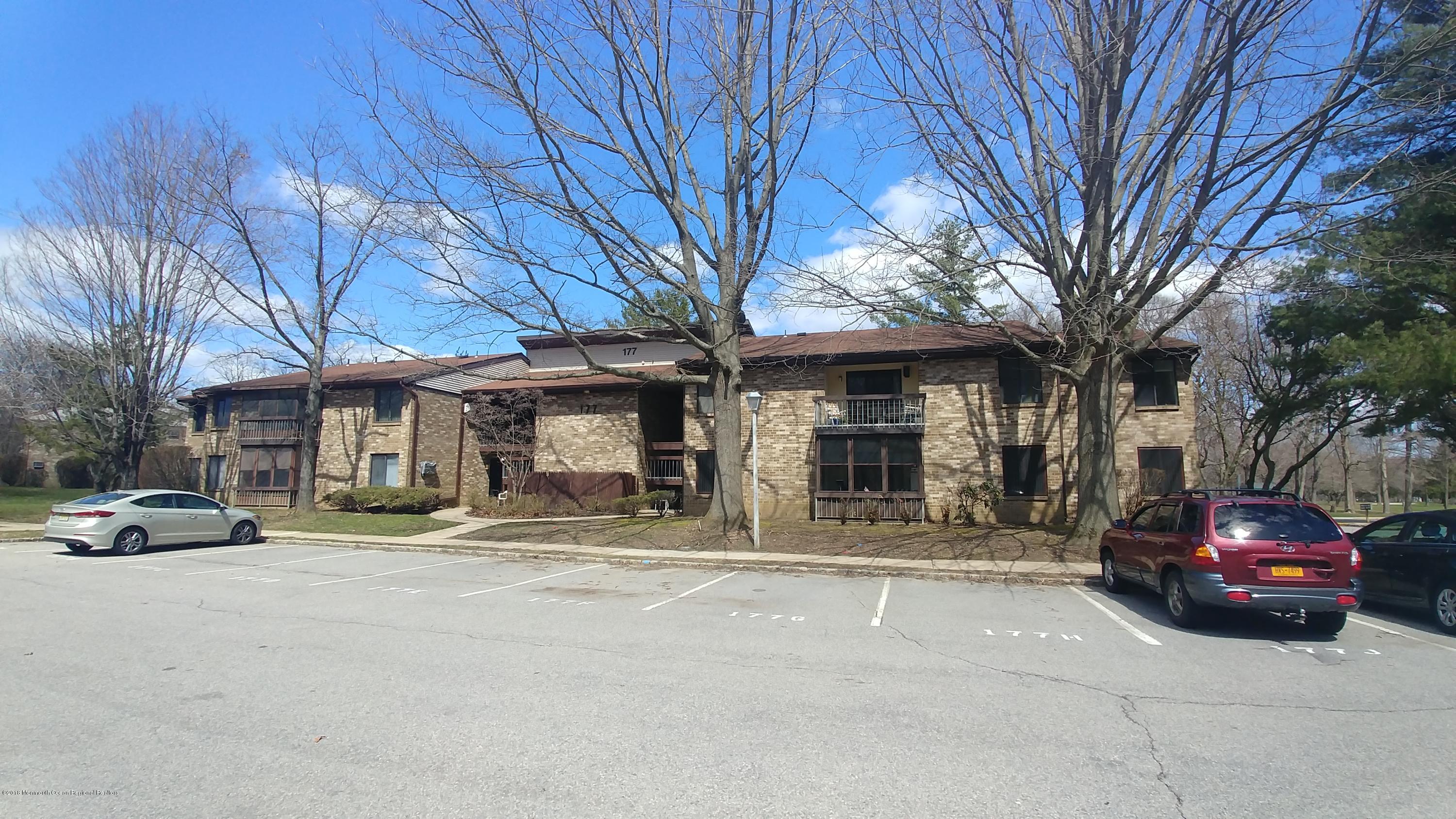 177 Amberly Drive, Unit K Manalapan, NJ 07726 - Photo 1 of 19 a car parked in front of a building
