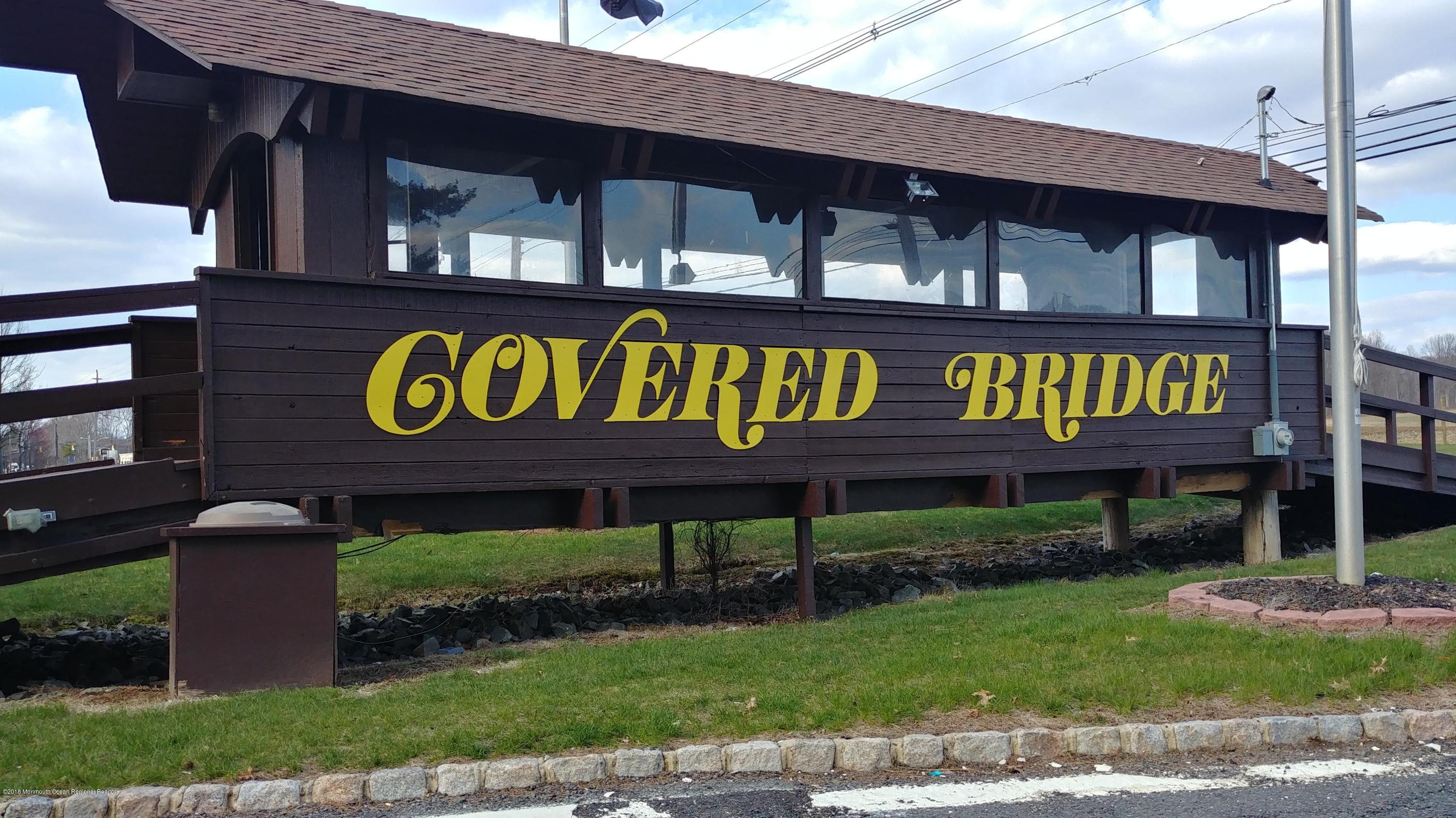 177 Amberly Drive, Unit K Manalapan, NJ 07726 - Photo 19 of 19 a sign that is sitting on a brick wall