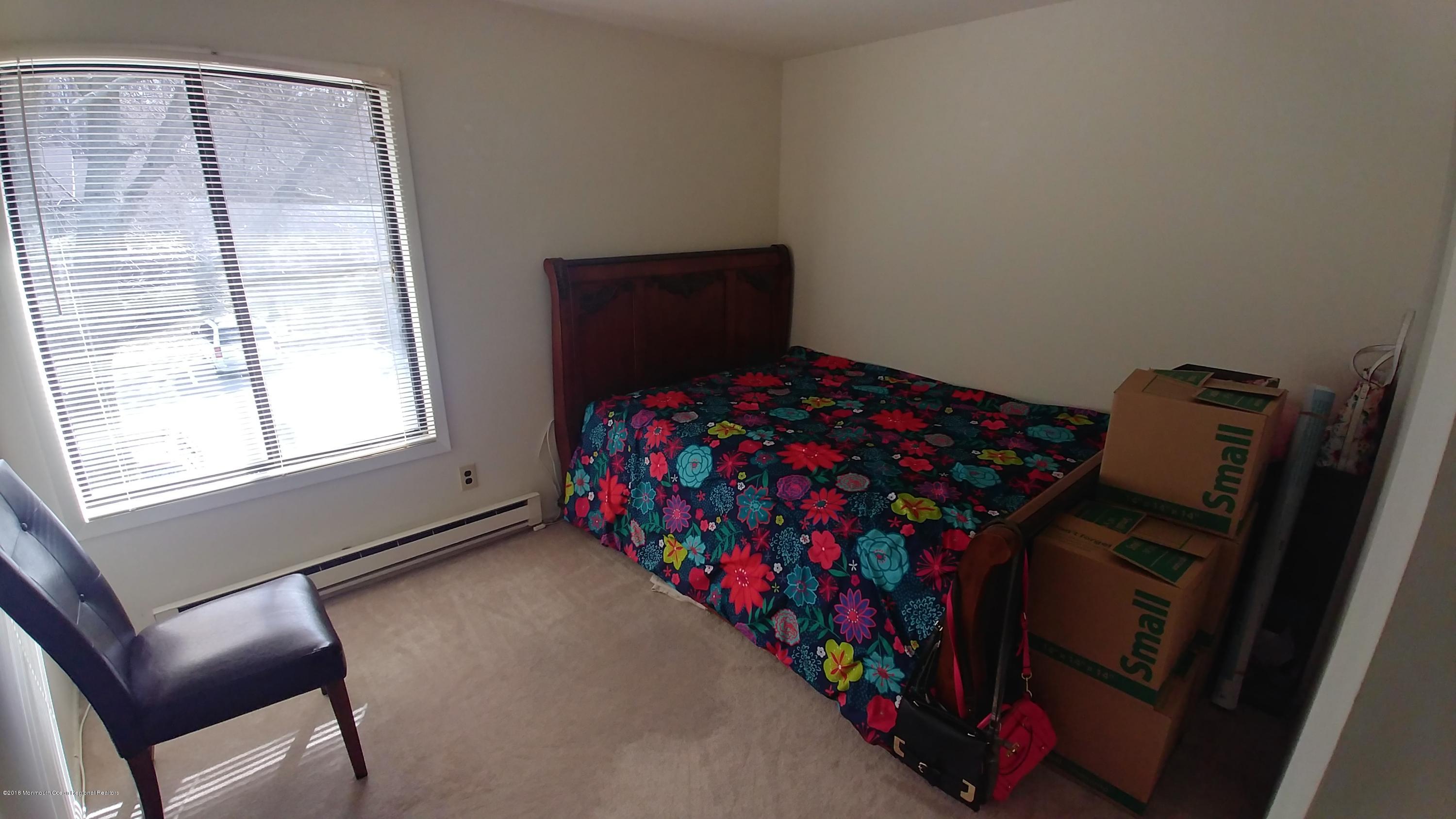 177 Amberly Drive, Unit K Manalapan, NJ 07726 - Photo 6 of 19 a bedroom with a bed and a window