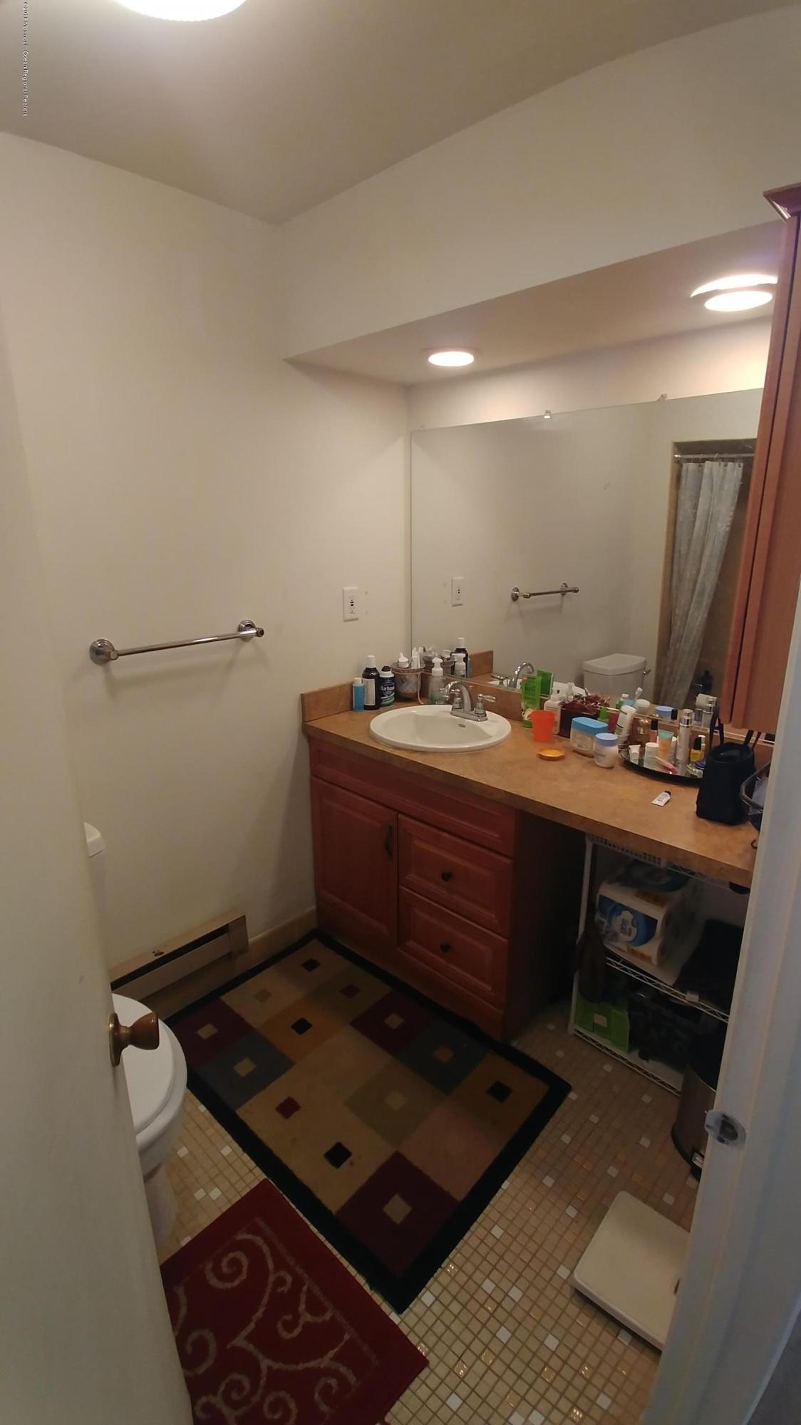 177 Amberly Drive, Unit K Manalapan, NJ 07726 - Photo 7 of 19 a room with furniture and mirror