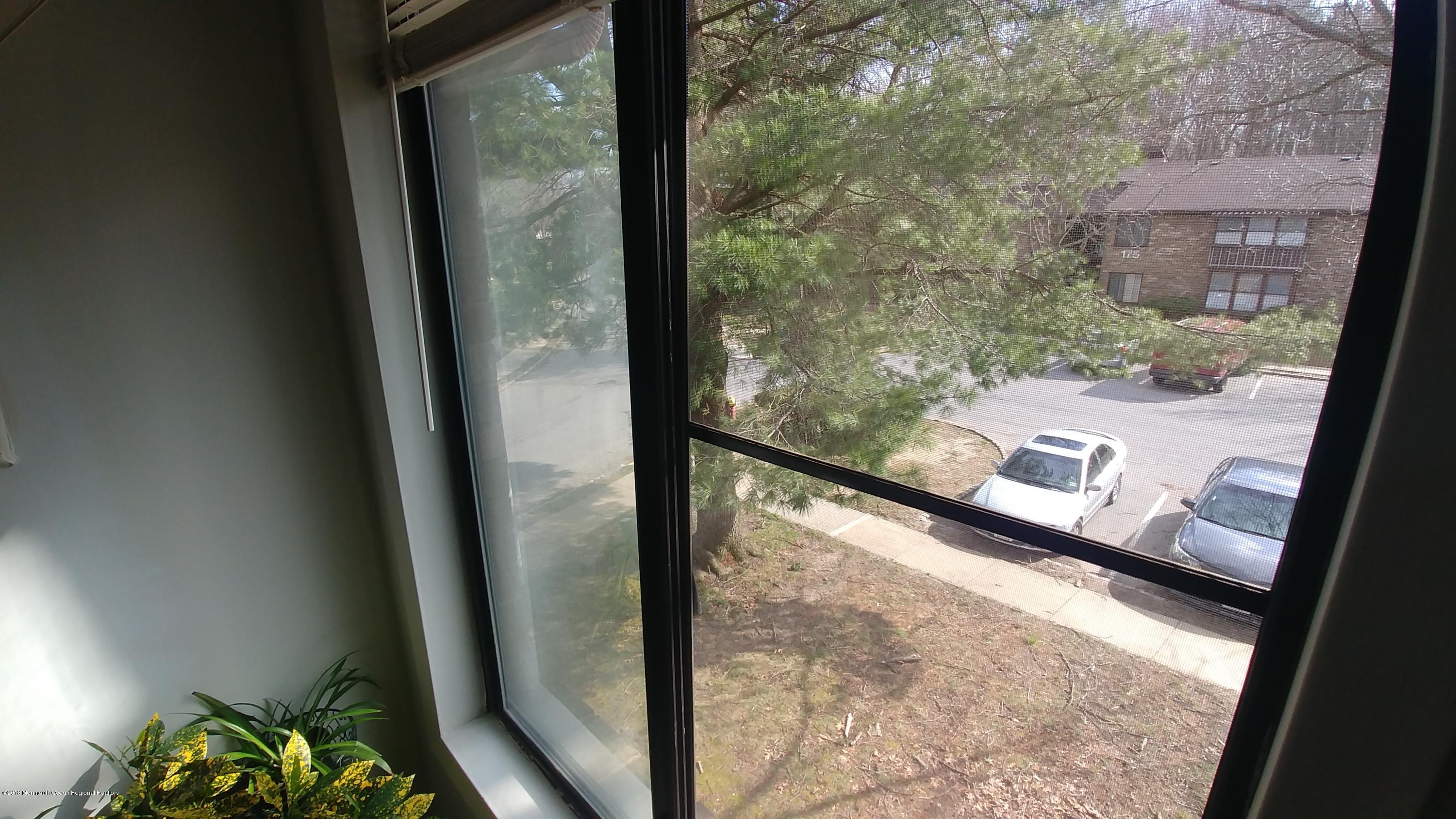 177 Amberly Drive, Unit K Manalapan, NJ 07726 - Photo 10 of 19 a view of a balcony with wooden floor