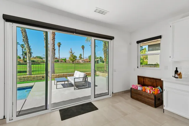 a living room with couch and a floor to ceiling window
