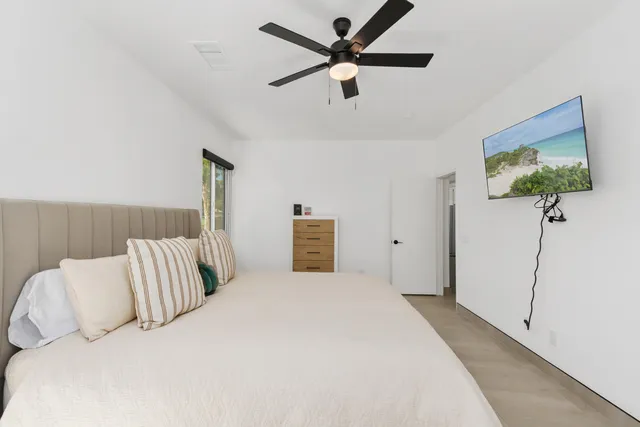 a bedroom with a bed and a painting on the wall