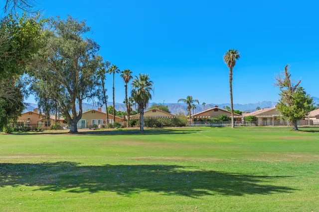 a view of a golf course with a house
