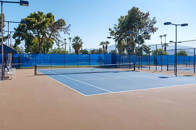 a view of a tennis court with a basket ball court