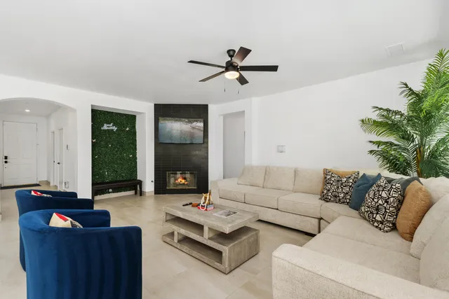 a living room with furniture and a potted plant