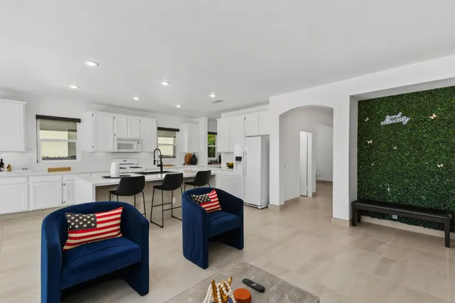 a living room with furniture a rug and a window